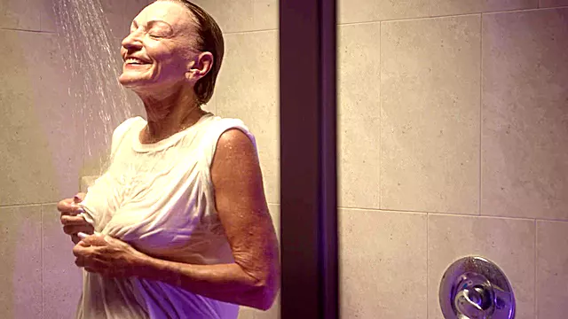 Granny Sydni Lane, 73 years young, showers in a white t-shirt