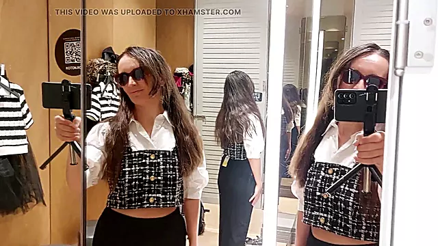 Latina tries on clothes in dressing room with hairy pussy, big boobs, and long hair